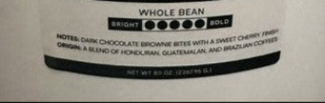 A package of Humm Cosechas Whole Bean coffee, featuring a white and black label with the brand logo and product details.